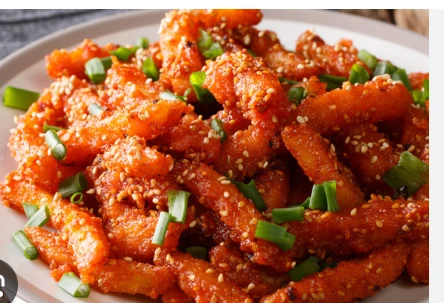HONEY CHILLI PATATO CRISPY PATATO COATED DEEP FRIED TOAST WITH ONION GARLIC CAPICUM AND HONEY CHILLI